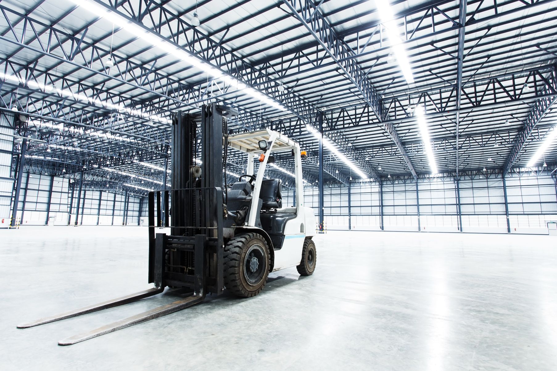 Warehouse with white forklift